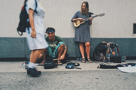 man and woman performing beside street thumbnail
