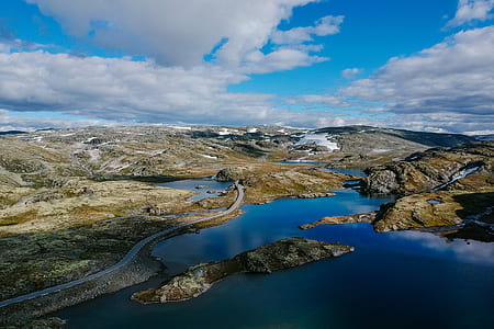 body of water near rock formations thumbnail
