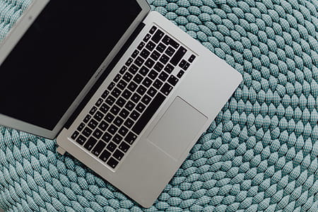 MacBook Laptop on a blue pouf thumbnail