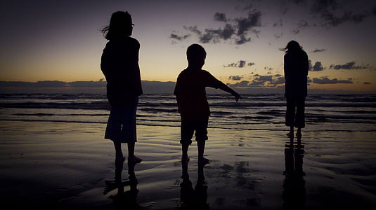 silhouette of people near body of water thumbnail