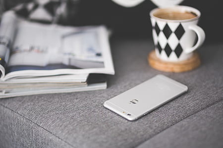 Close of phone on a grey couch thumbnail