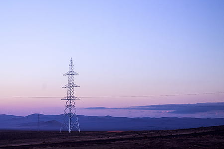white electricity post near mountain thumbnail