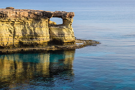 rock cliff near body of water thumbnail