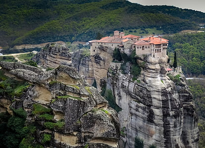 gray concrete castle on rock formations thumbnail