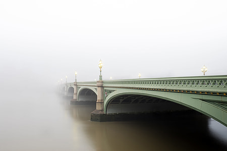 arch-shaped green concrete bridge under white clouds thumbnail