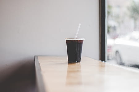 clear drinking glass with black liquid thumbnail