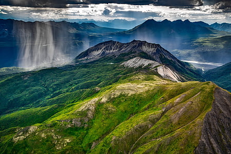 painting of green lush mountain under water waves thumbnail