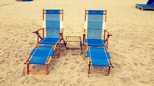 two blue beach lounge chairs thumbnail