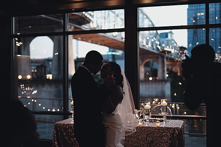 groom hugging bride standing beside table thumbnail