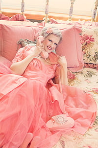 woman wearing pink dress holding pink telephone thumbnail