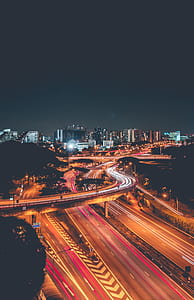 time-lapse photography of cars on road during night time thumbnail