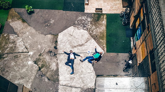 men lying on concrete pavement thumbnail