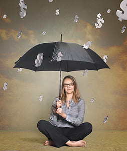 woman wearing gray long-sleeved shirt and black pants using black umbrella thumbnail