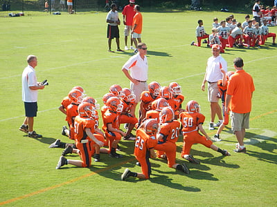 football team on field during daytime thumbnail