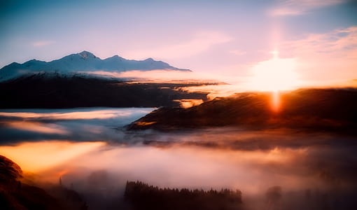 orange sunset with mountains with white clouds thumbnail
