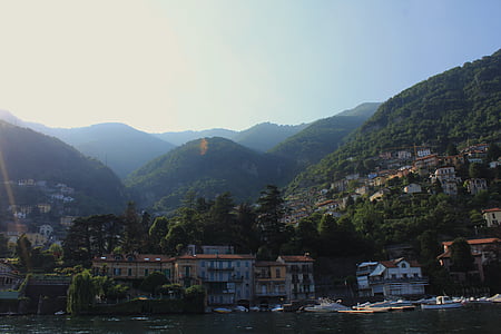 building near body of water and mountain thumbnail