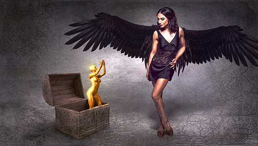 winged woman beside trunk with golden woman figurine thumbnail