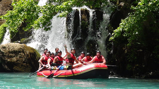 people riding in inflatable raft during daytime thumbnail