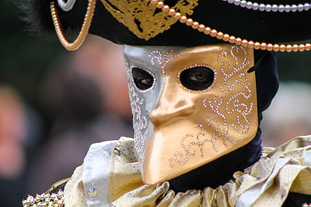 person wearing gold and black mask thumbnail