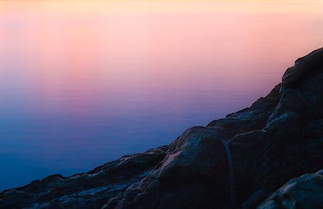 rock cliff near body of water thumbnail