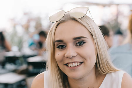 woman wearing white sleeveless shirt taking photo thumbnail