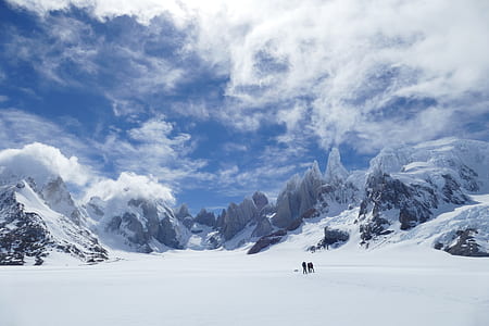 two person walking on mountain of snowfield thumbnail