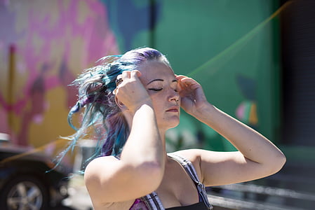woman in spaghetti strap top holding her head thumbnail
