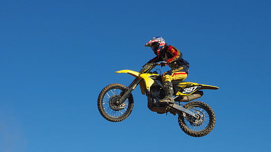 Man Riding Yellow Motocross Dirt Bike thumbnail