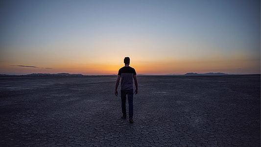 man walking on deserted field thumbnail