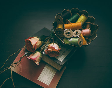 assorted-color sewing threads on brass bowl thumbnail