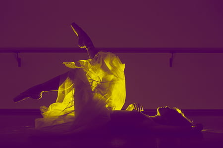 silhouette photo of woman doing ballet stunt while lying on surface thumbnail