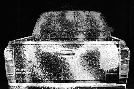 washed black pickup truck in black background thumbnail