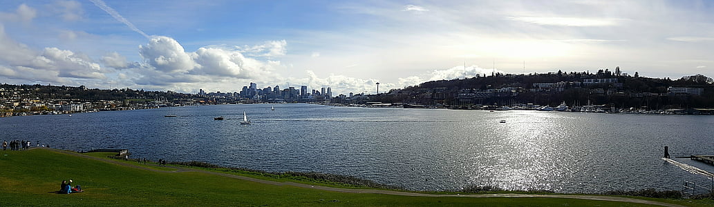 panorama photography of body of water under blue and gray skies thumbnail