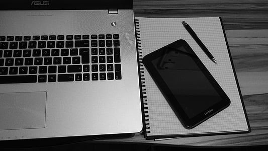 black tablet computer beside laptop thumbnail