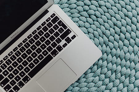 MacBook Laptop on a blue pouf thumbnail