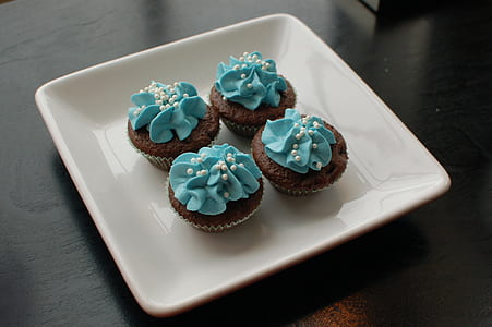 four cupcakes on white tray thumbnail
