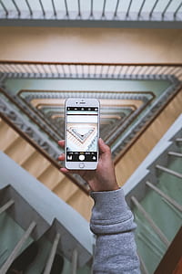 person holding silver iPhone 6 while taking photo thumbnail