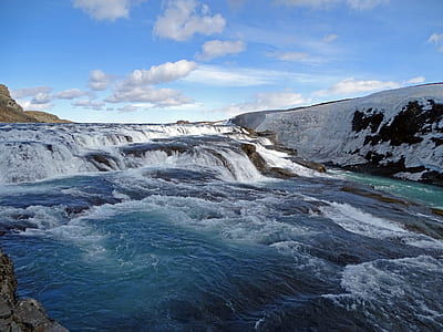 waterfalls under blue and white cloudy sky thumbnail