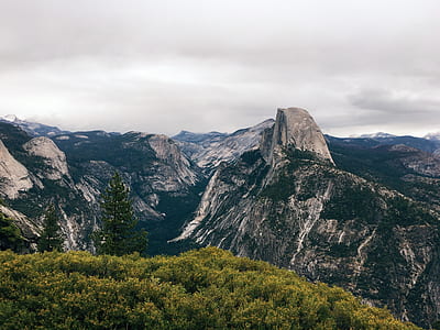 landscape photography of mountain ranges under cloudy sky during daytime thumbnail
