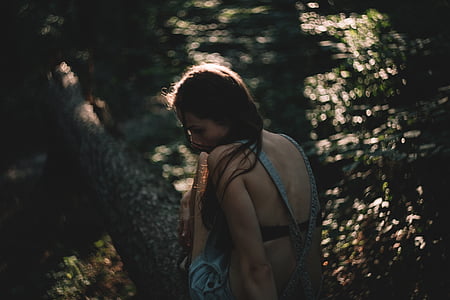 woman sitting on tree trunk thumbnail