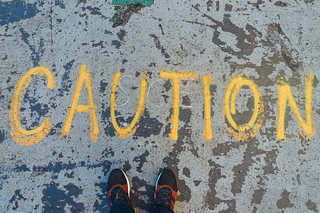 caution-painted sign on concrete floor d thumbnail