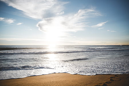 Sunrise over a Barcelona beach with waves approaching the shore thumbnail