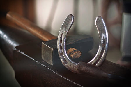 gray horseshoe beside mallet thumbnail