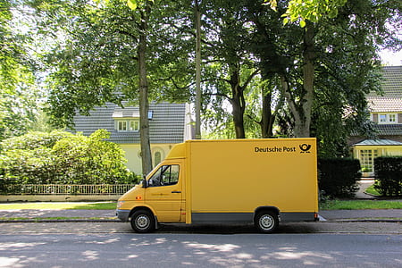 parked delivery truck near tree during daytime thumbnail
