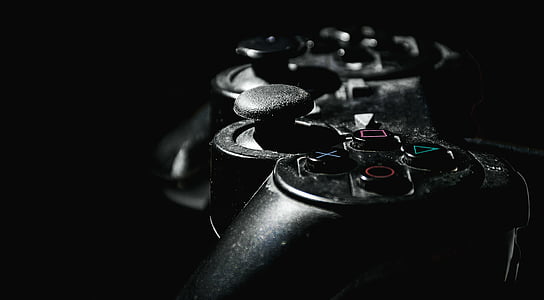 selective focus photography of black game controller thumbnail