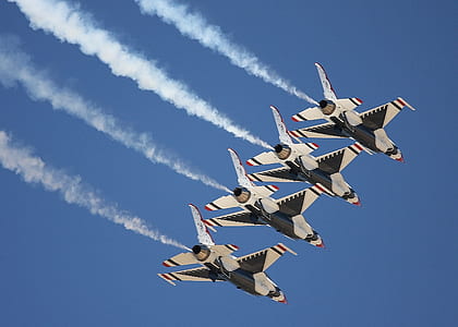 aircraft flying under blue skies daytime thumbnail