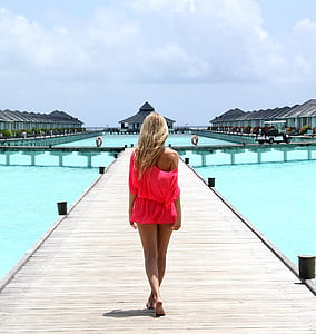 woman walking on wooden dock thumbnail