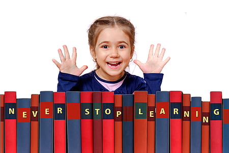girl standing in front of row books thumbnail