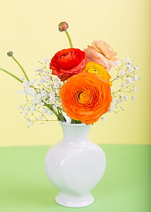 variety of flowers in vase with yellow background thumbnail