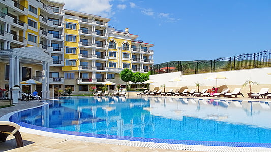 empty swimming pool beside building during day thumbnail